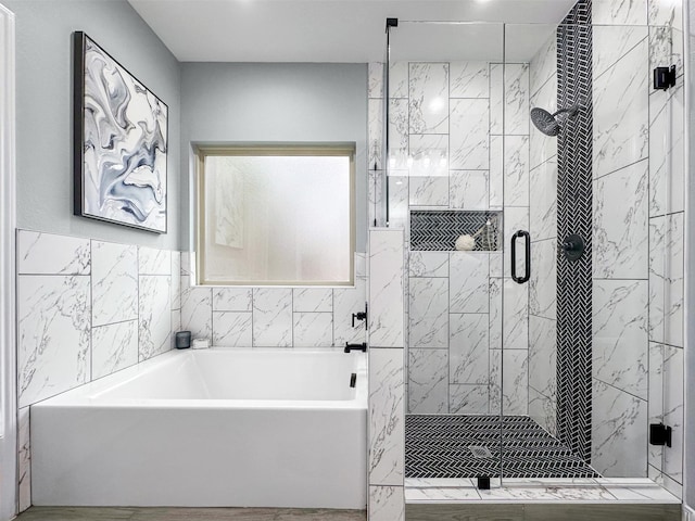 bathroom featuring shower with separate bathtub