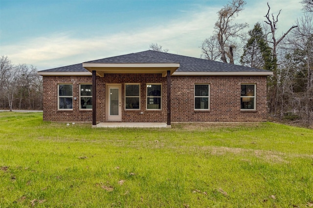 back of house featuring a patio area and a lawn