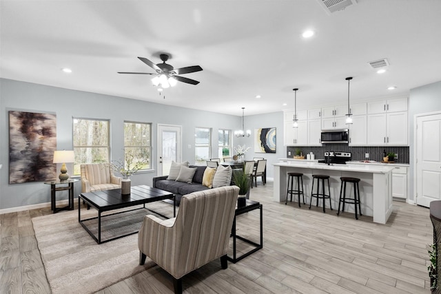 living area with recessed lighting, ceiling fan, and visible vents