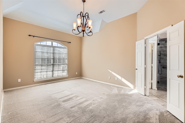 unfurnished room featuring light carpet, an inviting chandelier, and lofted ceiling