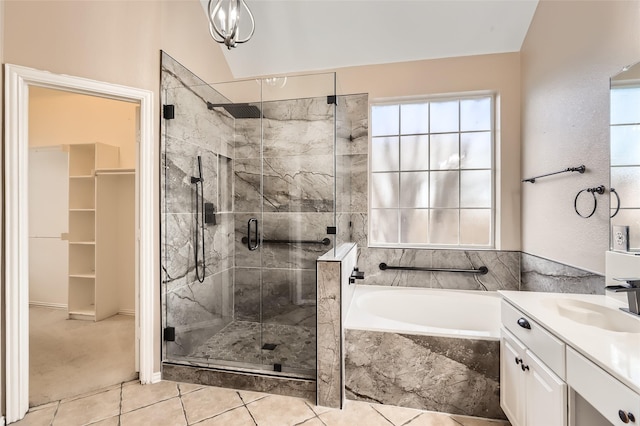 bathroom featuring lofted ceiling, vanity, tile patterned floors, and plus walk in shower