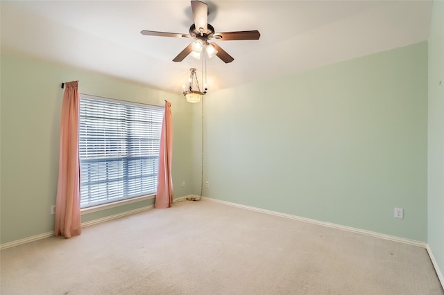 carpeted empty room featuring ceiling fan