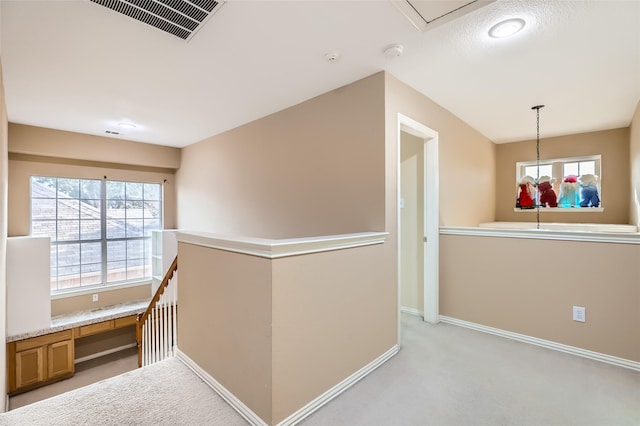 hallway with light carpet