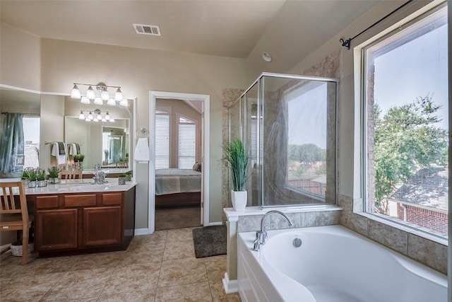 ensuite bathroom with a stall shower, vanity, a garden tub, and tile patterned floors
