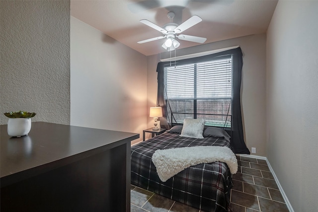 bedroom featuring dark tile patterned flooring and a ceiling fan