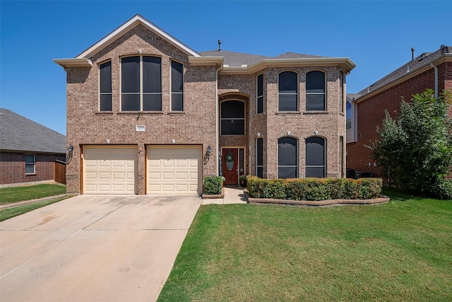 view of front of home with a garage and a front lawn