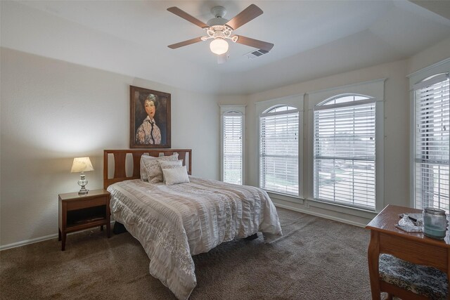 carpeted bedroom featuring multiple windows, ceiling fan, and baseboards