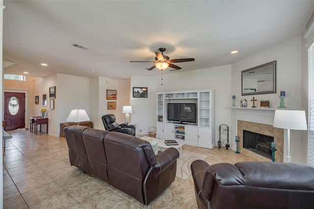 living area featuring a ceiling fan, light tile patterned flooring, recessed lighting, a tiled fireplace, and baseboards