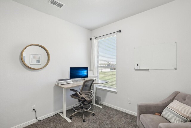 office area featuring dark colored carpet and a healthy amount of sunlight