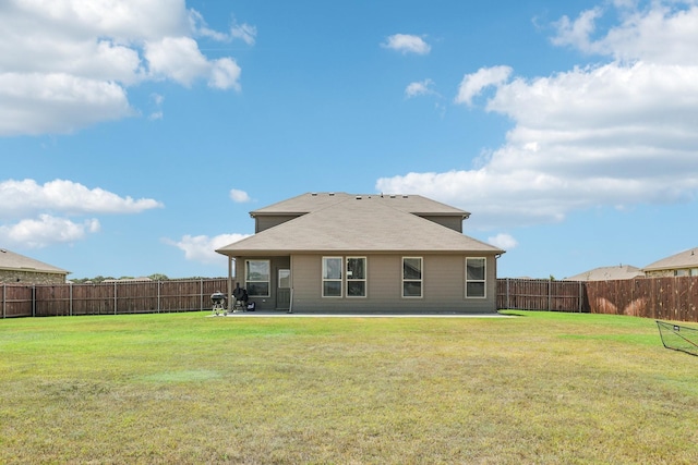 rear view of property with a patio area and a lawn