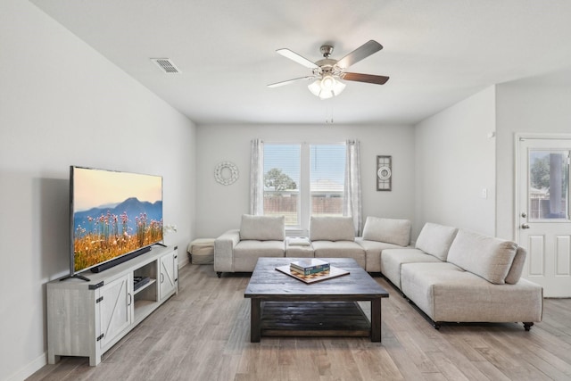 living room featuring ceiling fan and light hardwood / wood-style flooring