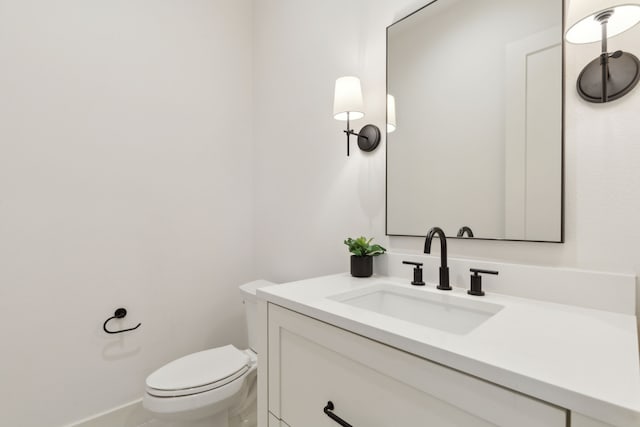 bathroom with toilet and vanity