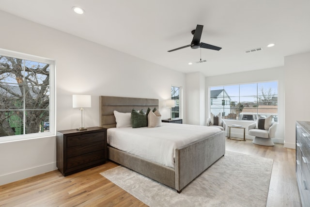 bedroom with ceiling fan and light hardwood / wood-style flooring