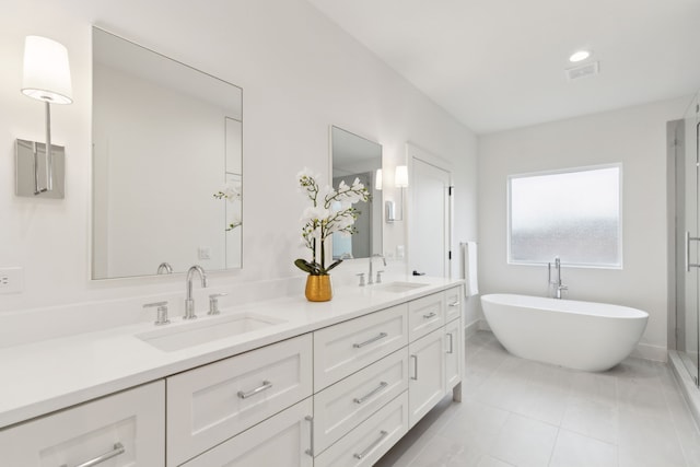 bathroom with plus walk in shower, tile patterned flooring, and vanity