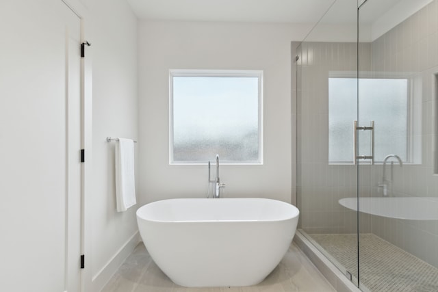 bathroom with separate shower and tub and tile patterned flooring