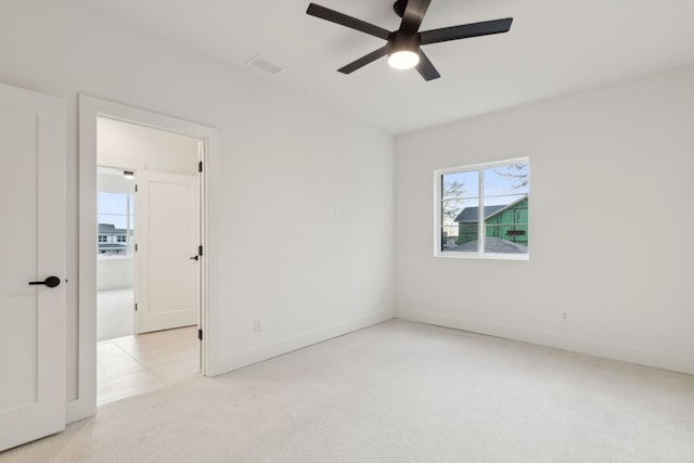 carpeted spare room with ceiling fan