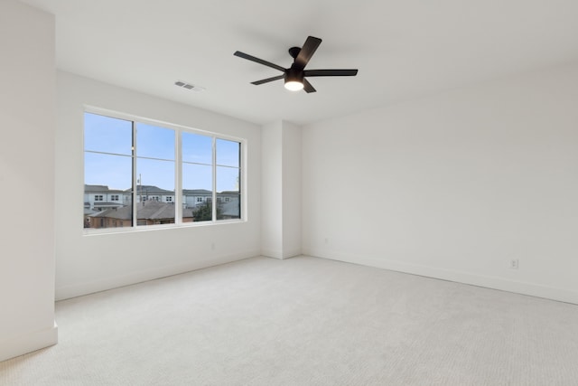 spare room featuring ceiling fan and light colored carpet