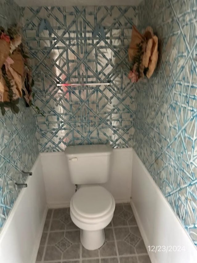 bathroom featuring toilet and tile patterned flooring