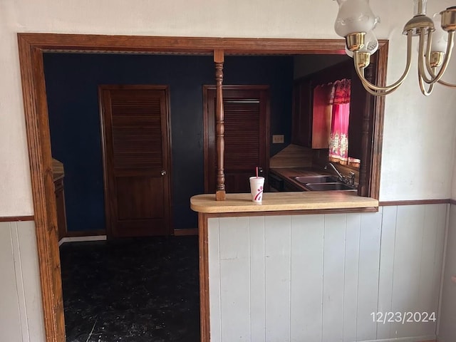 kitchen with sink and wooden walls