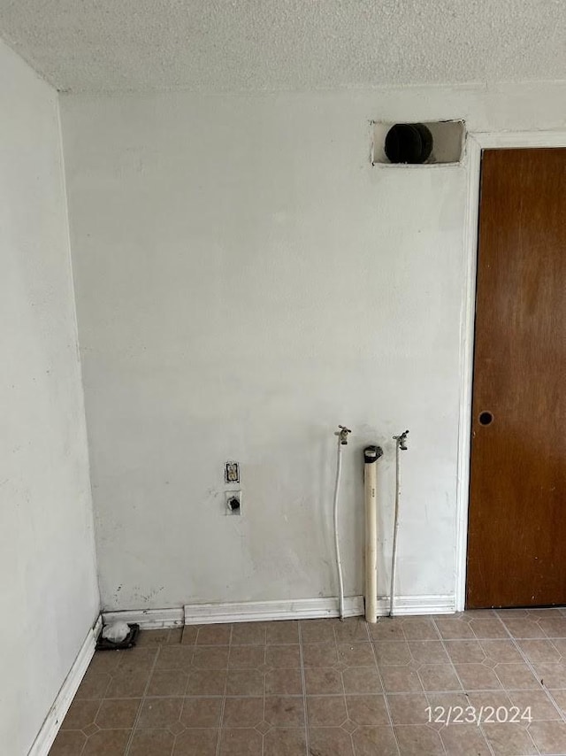 laundry area featuring a textured ceiling