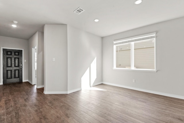 entryway with baseboards, wood finished floors, visible vents, and recessed lighting