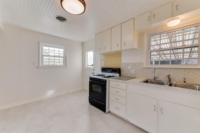 kitchen featuring white cabinetry, range with gas cooktop, decorative backsplash, and sink