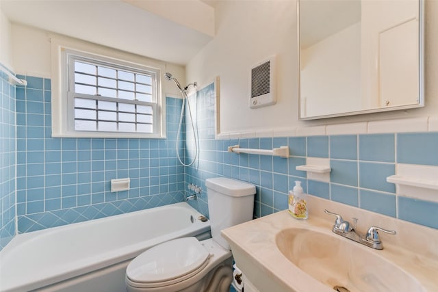 full bathroom with vanity, toilet, tile walls, and tiled shower / bath combo