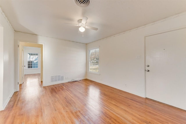 spare room featuring light hardwood / wood-style flooring and ceiling fan