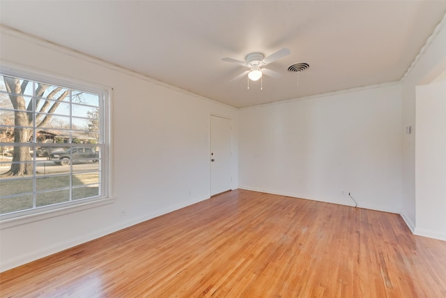 empty room featuring crown molding, light hardwood / wood-style floors, ceiling fan, and plenty of natural light