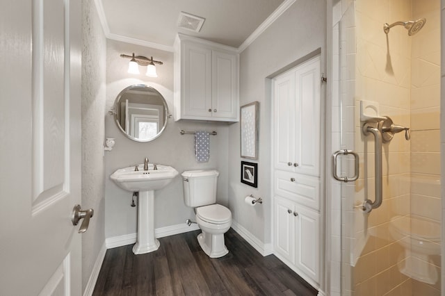 bathroom with toilet, wood finished floors, visible vents, baseboards, and a shower stall