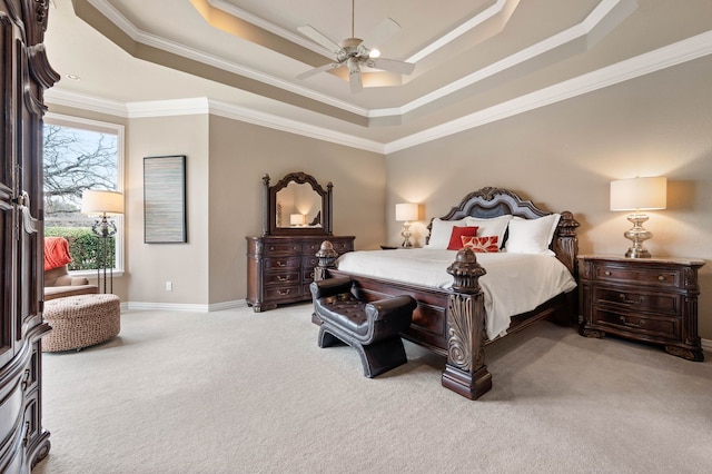 bedroom with light carpet, ceiling fan, a tray ceiling, and crown molding