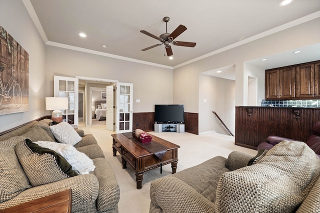 living area with recessed lighting, crown molding, french doors, and light colored carpet