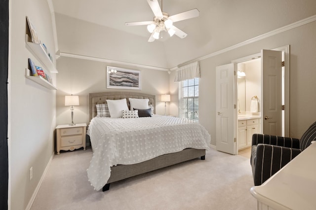 bedroom featuring lofted ceiling, connected bathroom, light carpet, baseboards, and crown molding