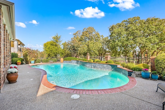 view of swimming pool featuring pool water feature and a patio area