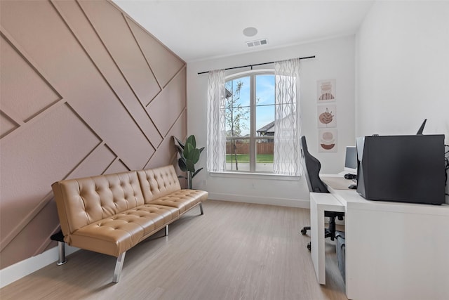 office featuring light wood-style floors, baseboards, and visible vents