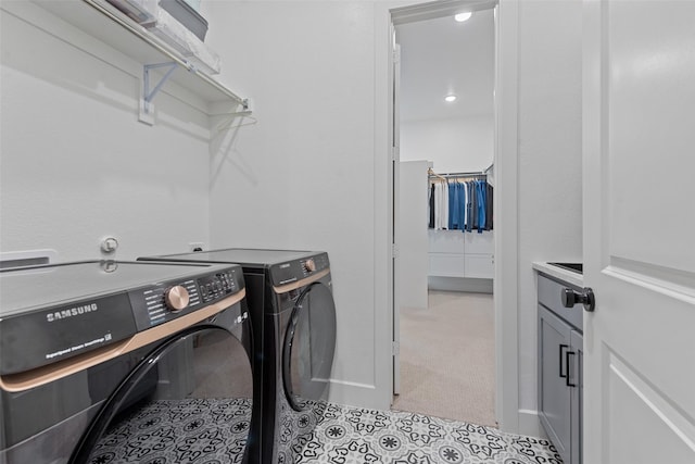 laundry area featuring cabinet space, washing machine and dryer, and baseboards