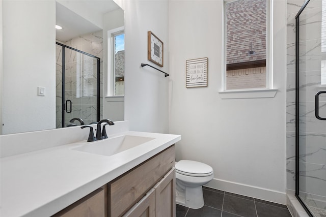 full bath featuring a marble finish shower, toilet, vanity, tile patterned flooring, and baseboards