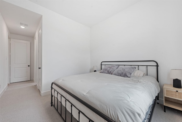 carpeted bedroom with visible vents and baseboards