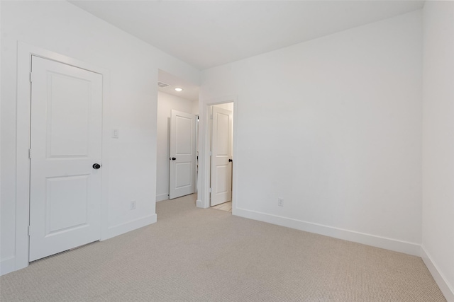 unfurnished bedroom with baseboards and light colored carpet