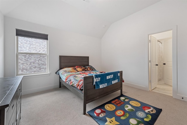 bedroom featuring lofted ceiling, baseboards, and carpet