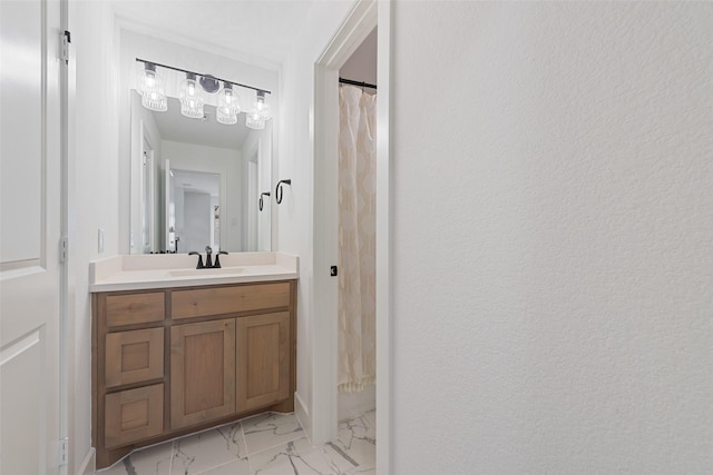 full bathroom featuring marble finish floor and vanity