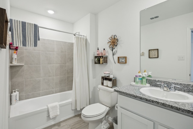 full bathroom featuring vanity, shower / bath combination with curtain, and toilet