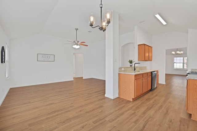 kitchen with light hardwood / wood-style floors, dishwasher, vaulted ceiling, ceiling fan with notable chandelier, and sink