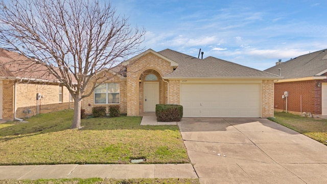 single story home featuring a front lawn and a garage