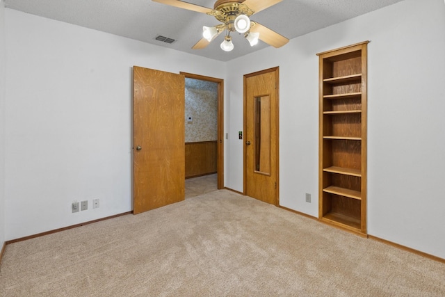 unfurnished bedroom with light carpet and ceiling fan