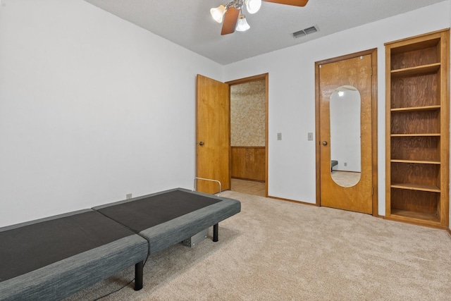 living area featuring ceiling fan and light carpet