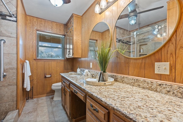 bathroom featuring ceiling fan, wooden walls, and a shower with shower door