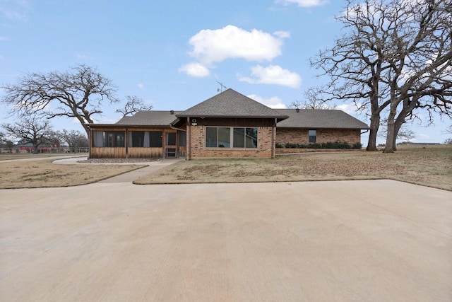 view of front of house with a sunroom