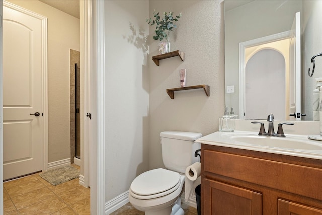 bathroom featuring vanity, toilet, and a shower with shower door