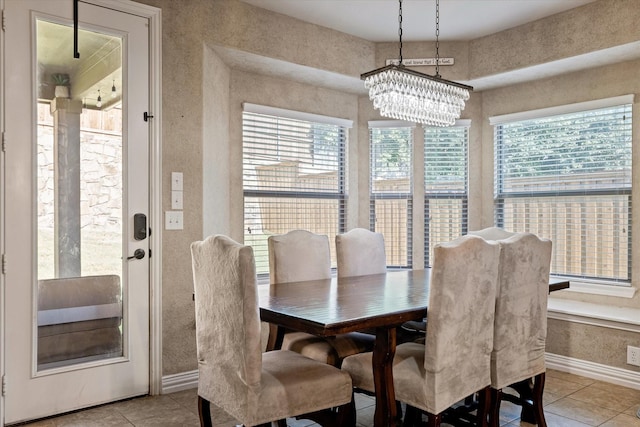 dining area with a healthy amount of sunlight, an inviting chandelier, and light tile patterned flooring